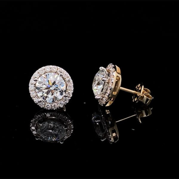 Pair of diamond stud earrings on a black background