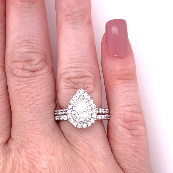 lab grown pear shape ring with halo setting in white gold with matching band on hand