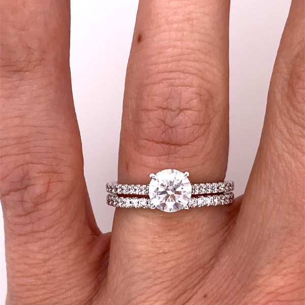lab grown diamond solitaire ring in white gold with matching band on hand