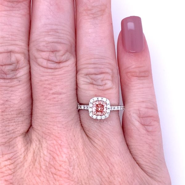 lab grown diamond ring with  cushion cut fancy pink diamond in the center and halo with white diamonds in 14k white gold on hand