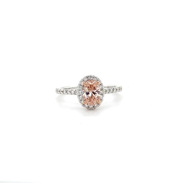 lab grown diamond ring with oval fancy pink diamond in the center and halo with white diamonds in 14k white gold