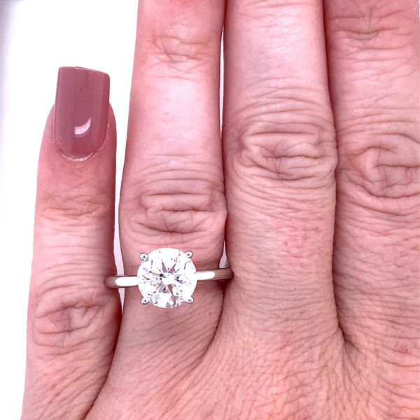 lab grown round cut solitaire ring in white gold on hand