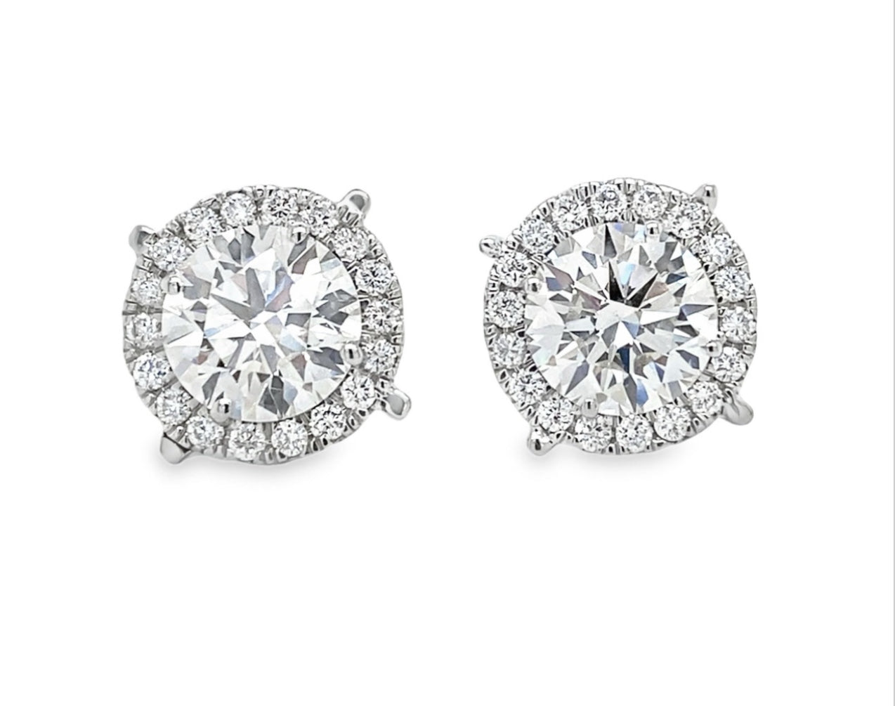 lab grown studs in halo setting in platinum
