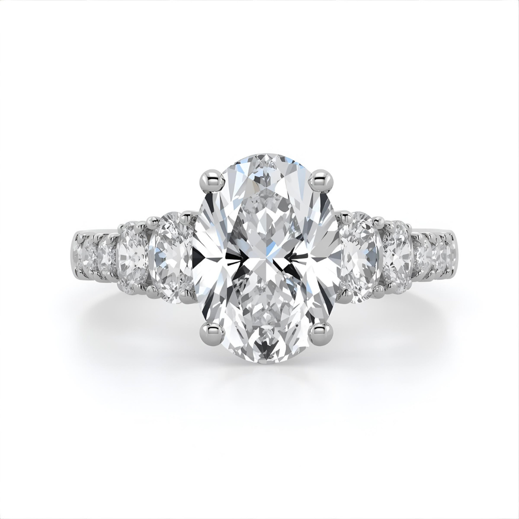 Diamond ring with a central oval-cut diamond and smaller oval diamonds on a white background Front 