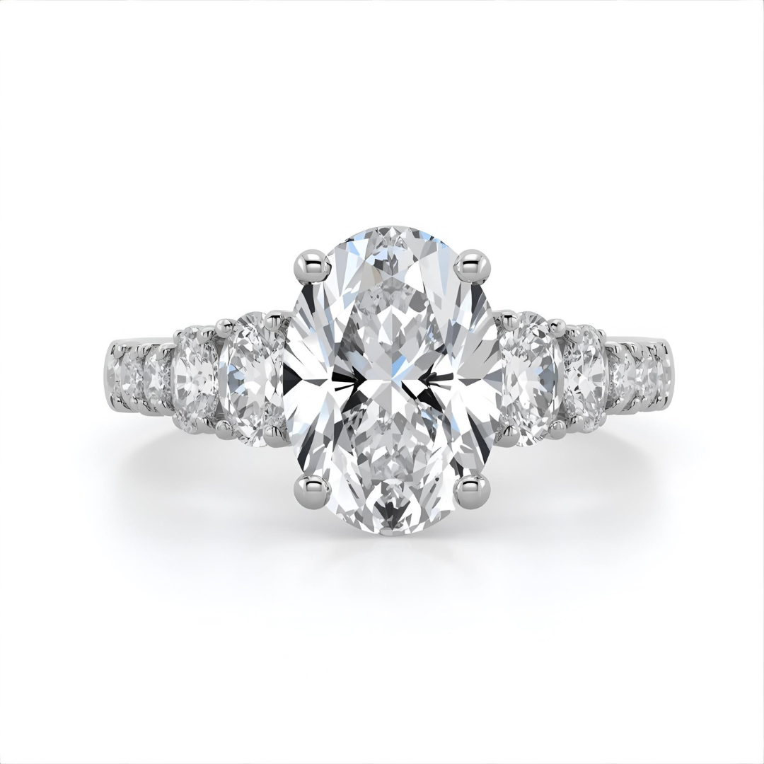 Diamond ring with a central oval-cut diamond and smaller oval diamonds on a white background Front 
